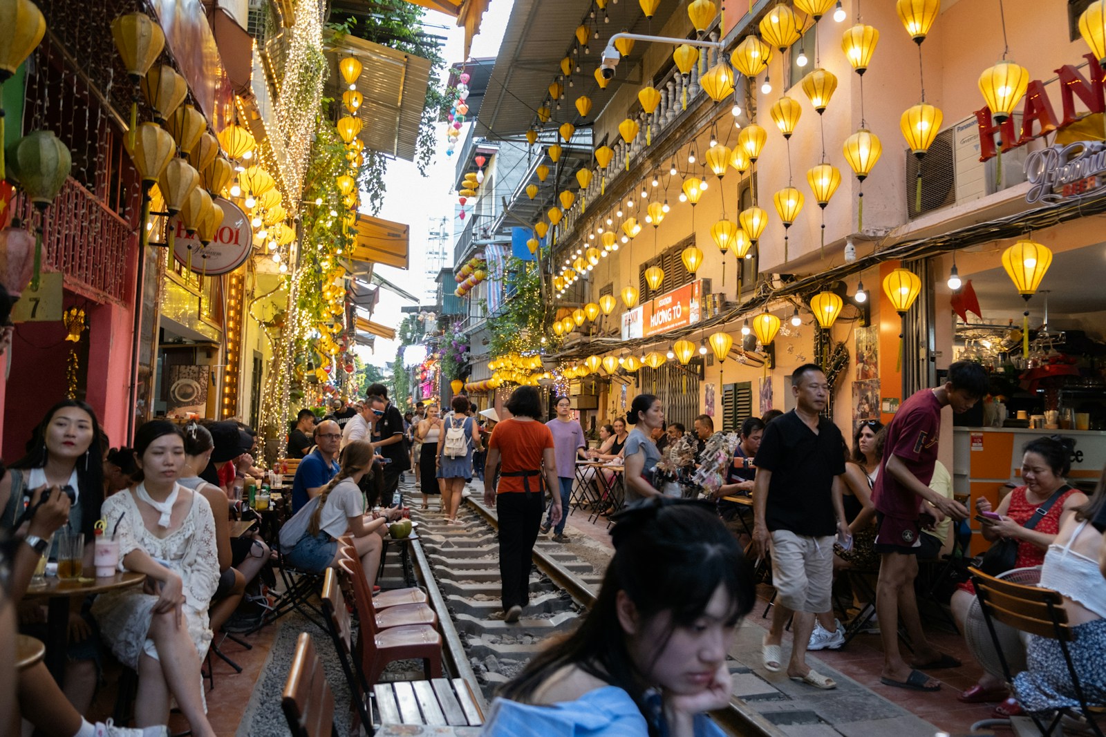 People walking through Hanoi’s train street, Vietnam.