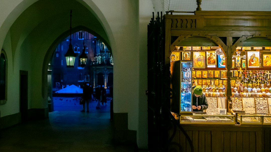 Illuminated bar counter with a worker beside a dark archway