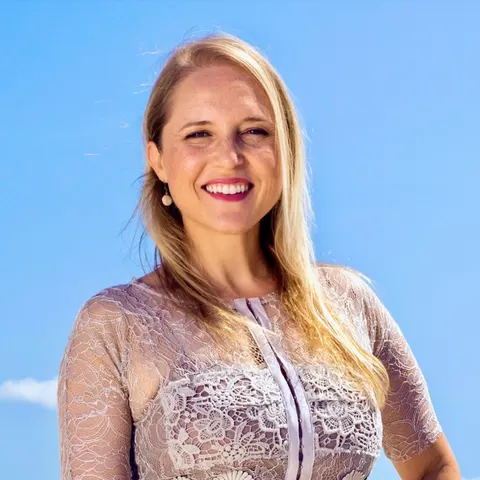 Traveling with Kristin smiling outdoors